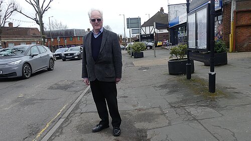 Simon standing on broken pavements